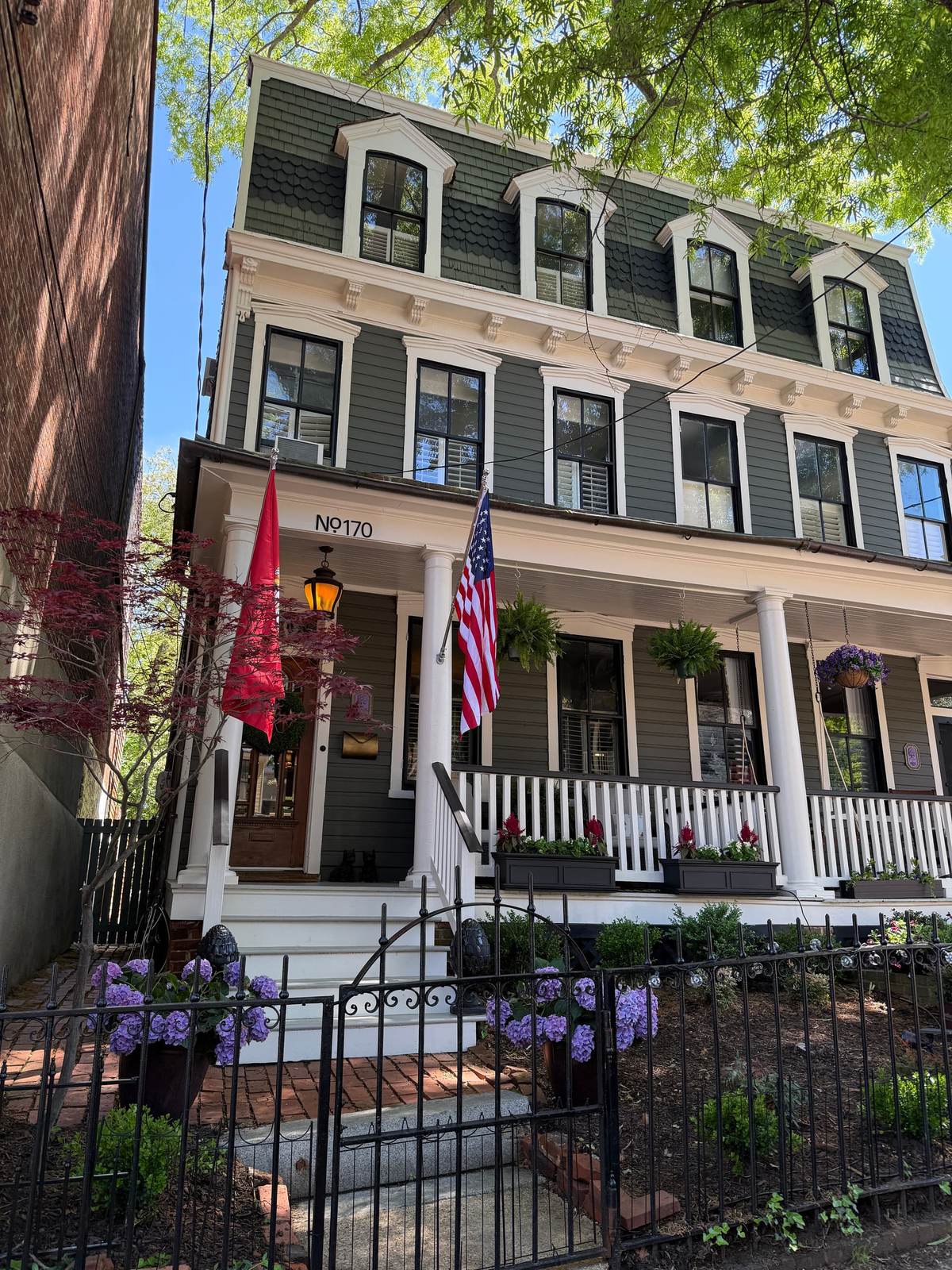 Strohm House, a three-story 1870 Victorian with a covered front porch in the Annapolis historic district, available as a 2027 legislative session rental